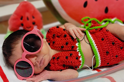 NICU baby dressed as a watermelon for July 4th