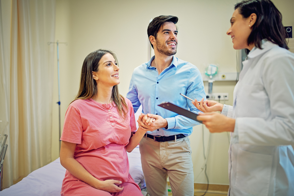 pregnant couple visiting OB